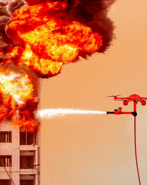 Fire,Fighting,Drone,Flying,For,Extinguish,A,Fire,On,The Fire fighting drone flying for extinguish a fire on the of a residential highrise building. in the sky